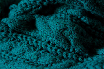 A close up of a cozy teal scarf