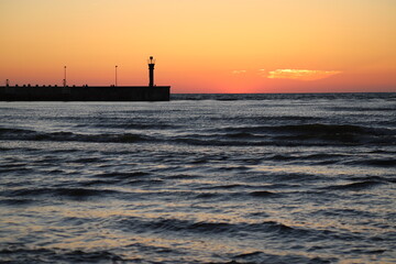 Sunset scenery with head of the east breakwater, Łeba, Baltic Sea, Poland