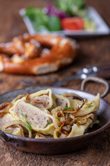 swabian maultasche with onions in a pan
