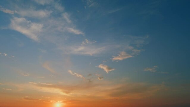 Orange and light yellow tones. Bright multicolored sky-cloud background. Nature background. Timelapse.