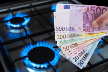 Blue fire on gas burner and paper money