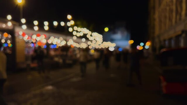 Night city street during weekend with people walking - Defocused image with bokeh