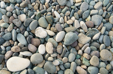 Texture of small sea pebbles. View from above.