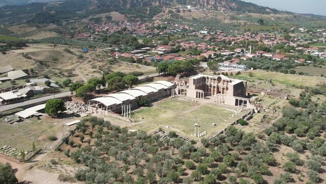 Aerial view with drone; Sardes (Sardis) Ancient City which has gymnasium and synagogue ruins and columns in Manisa, Turkey.