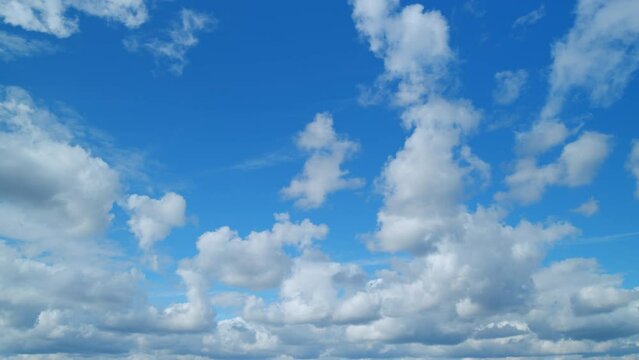 Beautiful blue sky with cumulus and cirrus on different layers clouds at day as abstract background. Fresh air. Timelapse.