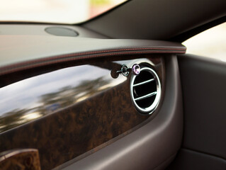 front panel made of rare wood and leather in a luxury car