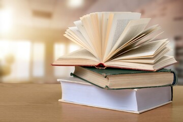 Reading book stack on wooden desk