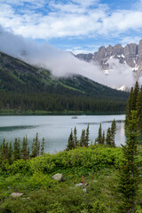 Lake Josephine in Glacier National Park as a boat passes by