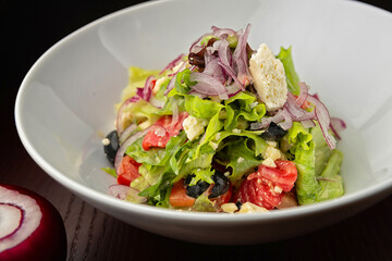 Greek salad on a plate. Shallow depth of field