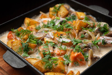 Fried potatoes with salmon and mushrooms with sauce