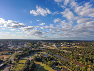 an aerial shot of a gorgeous autumn landscape at Carolyn Crayton Park at sunset with a river, lush...