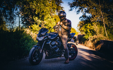 biker on a black sport motorcycle in algarve