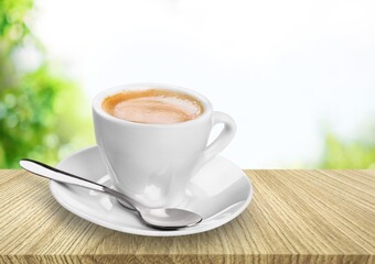 Cup of fresh aroma coffee and spoon on table