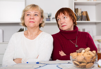 Two offended senior women dont speaking after quarrel at home