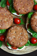 Healthy sandwiches with Philadelphia cheese, spinach and cherry tomatoes with rye buns.
