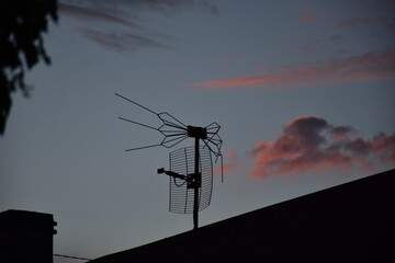 Antenna above the roof in the evening