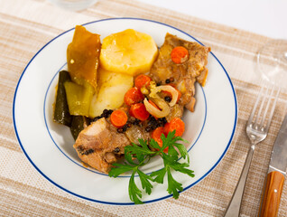 Juicy tender pork ribs stew with potatoes garnished with fresh parsley
