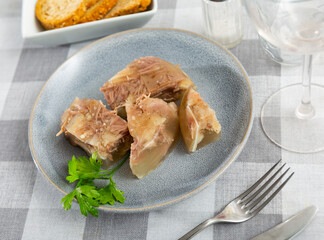 National dish of Russian cuisine is a kholodets, made from a jelly-like mass of cooling meat broth...