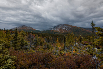 View of Baxter Peak from Chimney Pond Trail overlook in Maine with brilliant fall foliage 