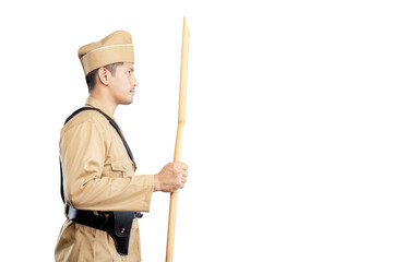 Indonesian freedom fighter standing while holding sharpened bamboo stick