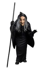 Old witch in a cloak standing with a stick