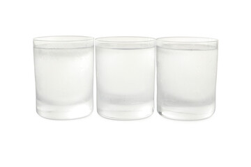 Vodka in shot glasses on white background