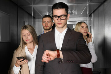 Group of office workers in modern elevator © New Africa