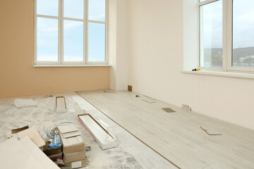 Light spacious room with unfinished laminate flooring