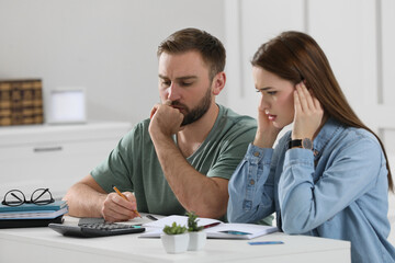 Young couple discussing family budget at home