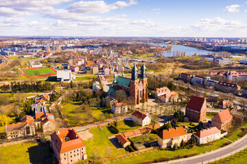 View from drone of ancient Gothic building of Roman Catholic Archcathedral Basilica of St. Peter and St. Paul on island of Ostrow Tumski in Poznan in spring, Poland - obrazy, fototapety, plakaty