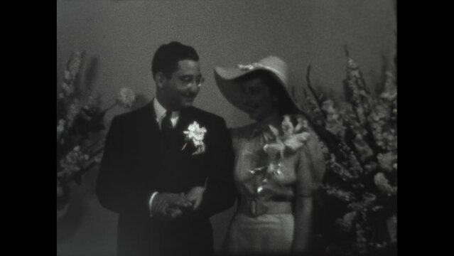 Newlyweds Pose 1938 - A newlywed couple poses for pictues after their wedding in Los Angeles, California in 1938.