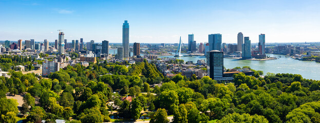 Summer Rotterdam cityscape on banks of Nieuwe Maas river with view of modern high-rise buildings...