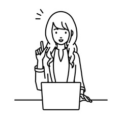 デスクで座ってPCを開いて何かひらめいたジャケットの女性
