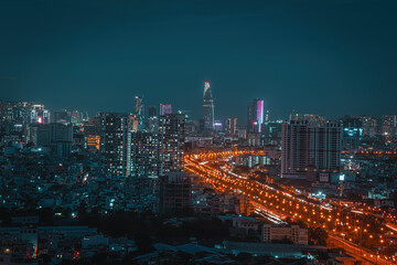 Aerial view of Bitexco Tower, buildings, roads, Vo Van Kiet road in Ho Chi Minh city - Far away is Landmark 81 skyscraper. Travel concept.