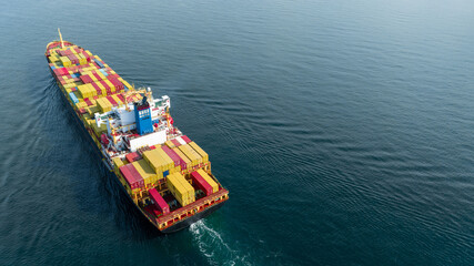 Stern of large cargo ship import export container box on the ocean sea on blue sky back ground...