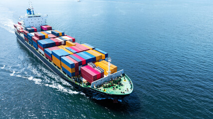 Aerial front of cargo ship carrying container and running