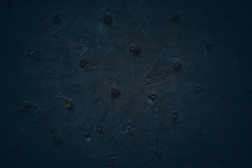 Rock texture. Dark stone wall. Stone background. Rock surface with holography, nacre. Wall abstraction. Paint spots. Rock surface with cracks. Abstract texture.
