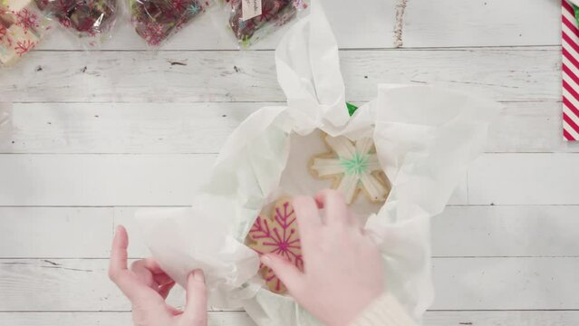 Flat lay. Step by step. Packaging homemade fudge and cookies into a Christmas gift box.