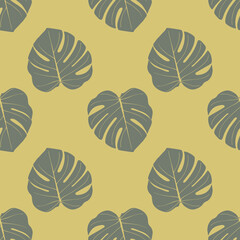 Seamless pattern with tropical leaves in a natural green palette.