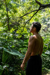 young man, doing yoga or reiki, in the forest very green vegetation, in mexico, guadalajara, bosque...