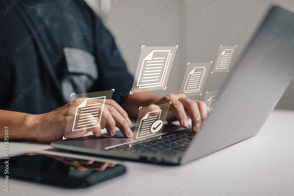 Leinwandbilder Document management data system business internet technology concept of a businessman hand using a laptop computer with a document management icon.