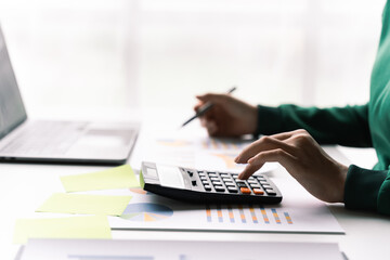 businesswomen working on desk office, calculating balance, finance accounting concept.