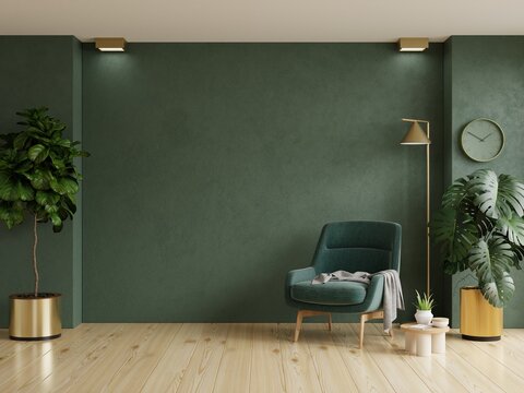 Bright and cozy modern living room interior with green armchair and decoration room on empty dark green wall background.