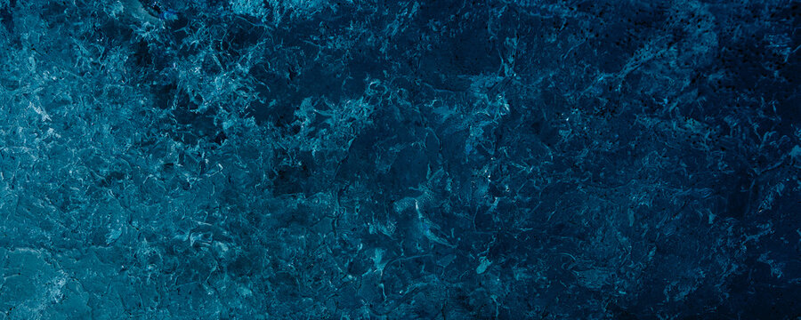 Close-up glacier ice. dark blue textured background banner