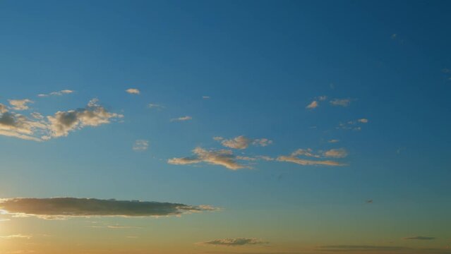 Evening sky at sunset in different shades. Beautiful romantic and colorful sky with brightly gradient color. Timelapse.