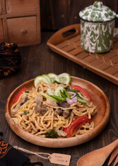 Mie Goreng Jawa or bakmi jawa or java noodle with spoon and fork. Indonesian traditional street...