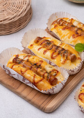 Sausage bread with yellow cheddar cheese, mayo and ketchup. Selective Focus. Popular Savory bread