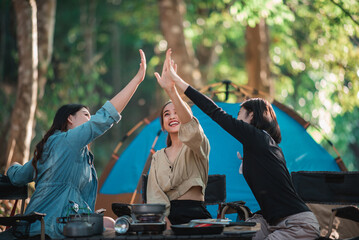 Group of women giving five to each other on camping