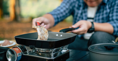 Portrait of Asian traveler man glasses pork steak frying