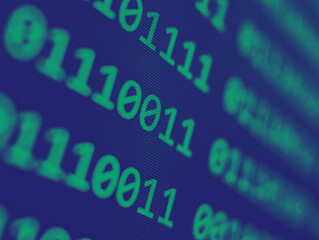 Binary computer code with grid of pink 1s and 0s displayed on a blue screen with focus blur effect